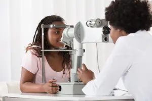 Image of a doctor examining a young girl's eyes