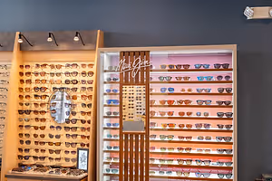A display of sunglasses with a sign reading Maui Jim