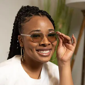 Woman adjusting glasses and smiling for a photo