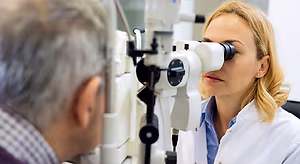 Ophthalmologist examining patient with slit lamp