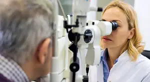 Ophthalmologist examining patient with slit lamp
