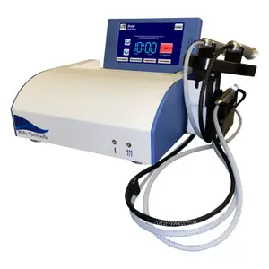 An image of a MiBo Thermoflo device with a blue and white color scheme and a digital display, connected to a power outlet and cables, placed on a white background.