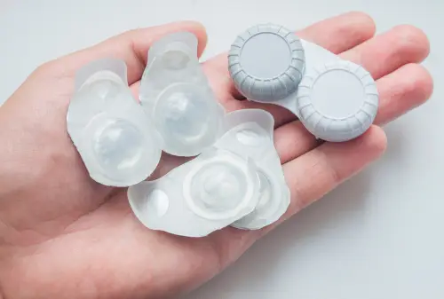hand holding daily disposable contact lenses