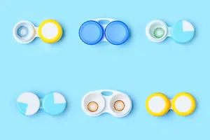 Six pairs of colored contact lenses in various colors and sizes on a blue background.