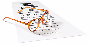 A pair of glasses on an eye test chart