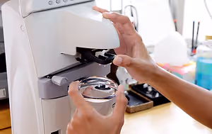 Close up of a person using a microscope in a laboratory