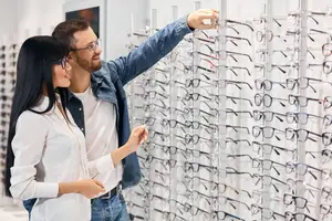 A couple in a store looking at glasses on display