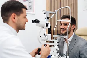 Man having his eyes examined by an optometrist in a clinic