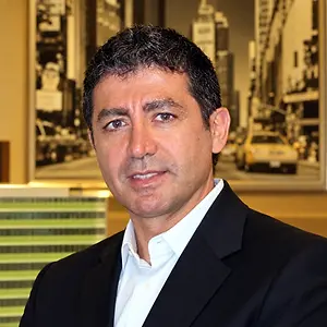 Portrait of a man in a black suit and white shirt
