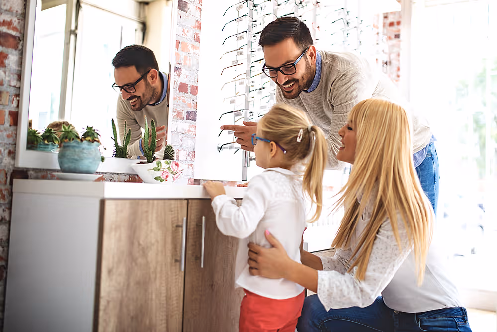 A family choosing eyeglass frames together