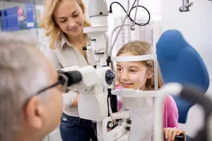 Girl at an optometrist's office with an adult man and woman