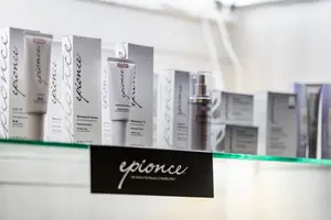 A display of Epionce skincare products on a glass shelf