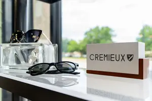 Black sunglasses with the word Cremieux on a white background
