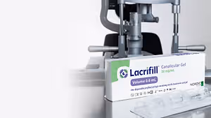 Lacrifill Canalicular Gel is packed in a white box with green and purple detailing, placed on a table next to a medical device.