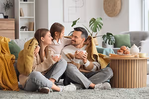 Family relaxing together on a living room floor