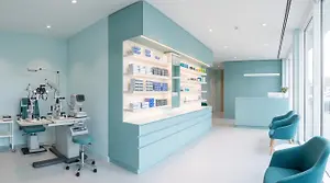 An interior of a clinic with a white and blue color scheme and modern medical equipment