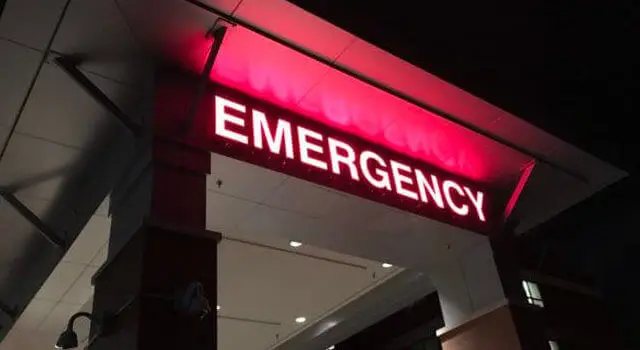Emergency sign with red light in a hospital at night