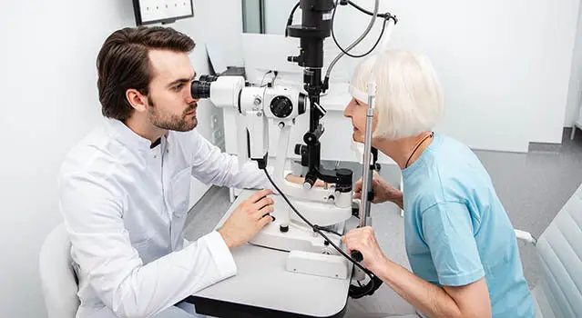 Senior woman undergoing an eye exam with an optometrist